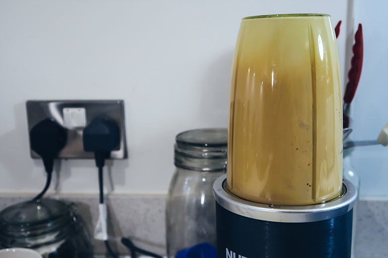 mixing butter coconut oil and coffee in a blender